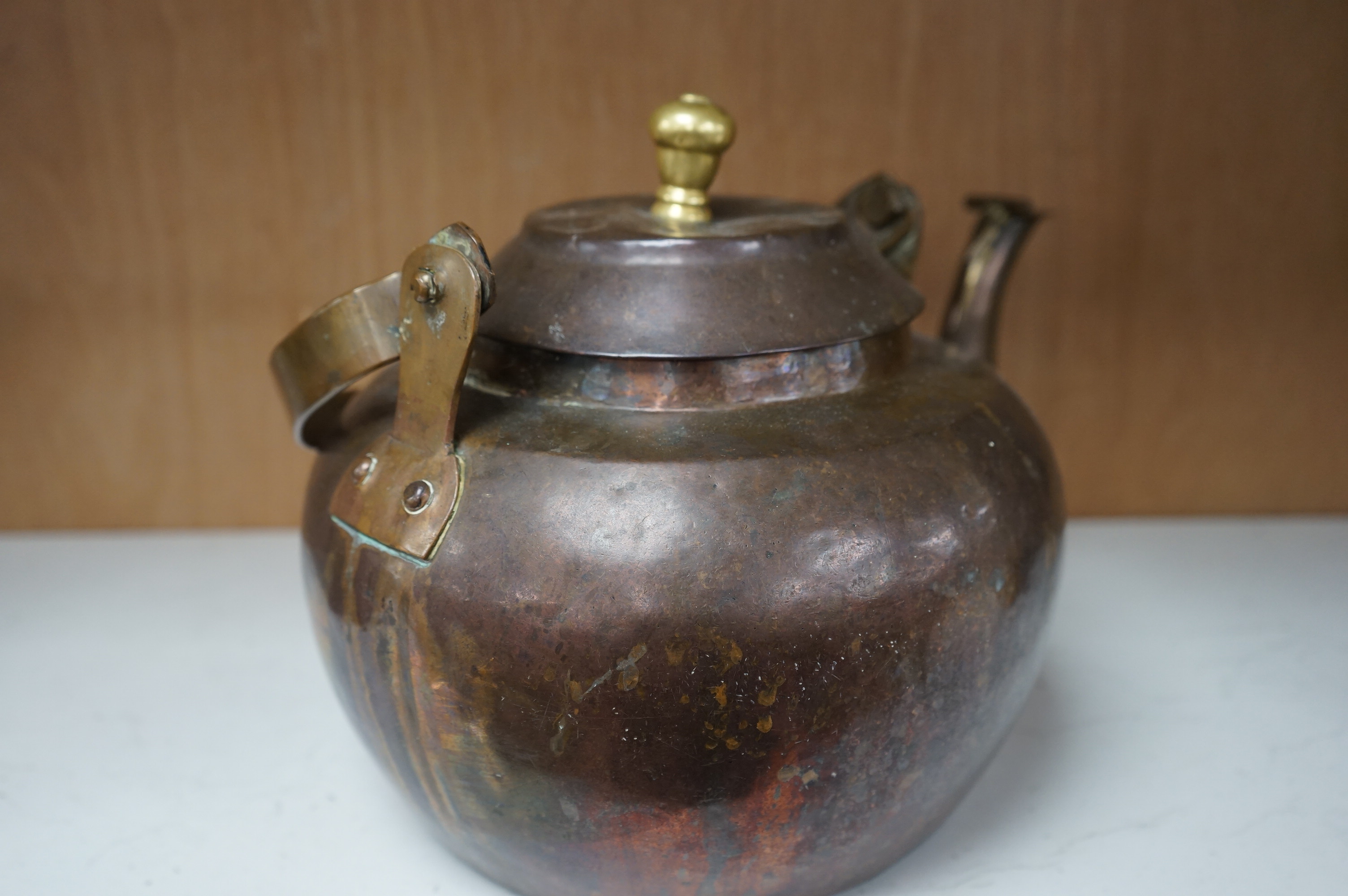 A Dutch copper kettle with brass knop, 34cm wide. Condition - fair